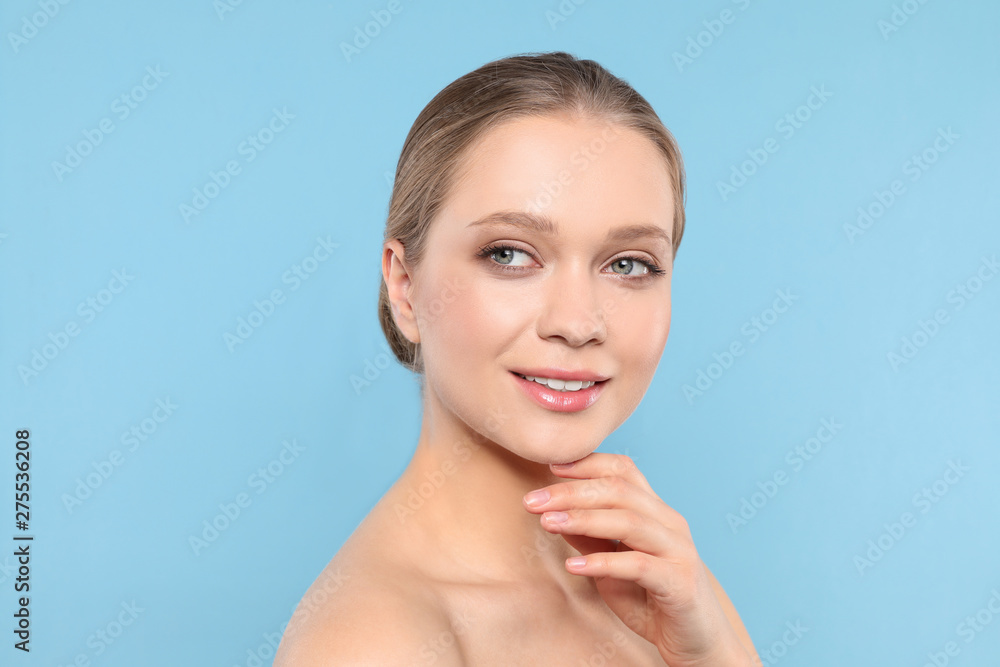 Portrait of young woman with beautiful face on blue background Portrait of young woman with beautiful face on blue background