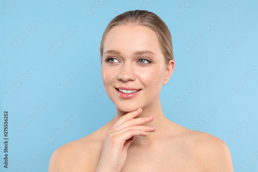 Portrait of young woman with beautiful face on blue background Portrait of young woman with beautiful face on blue background