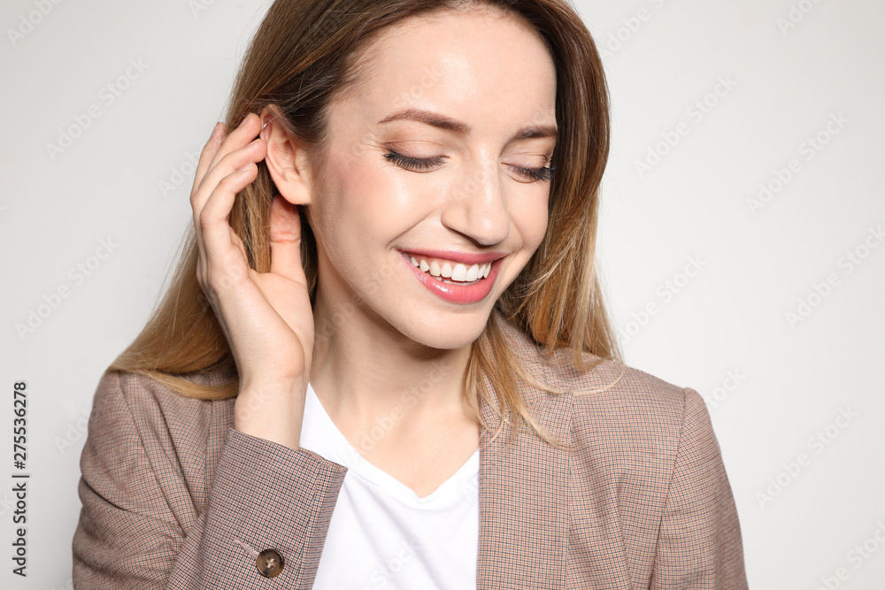 Portrait of young woman with beautiful face on light background, closeup Portrait of young woman with beautiful face on light background, closeup