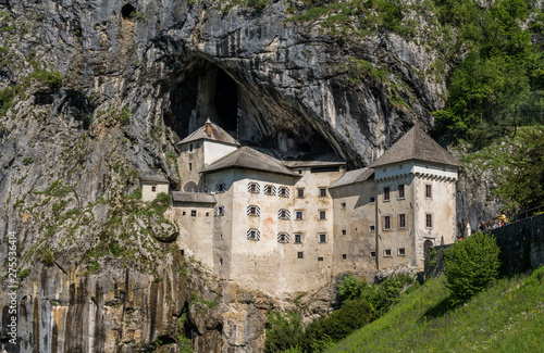 Famous castle of Predjama built into a cave in mountain in Slovenia photo