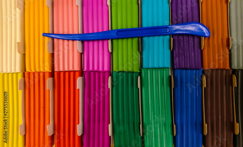 Color modeling clay with a plastic knife.
