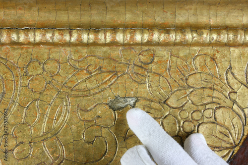 Restoration: gold restoration, old icon. close up. conservation of paintings. conservation of sculptures photo