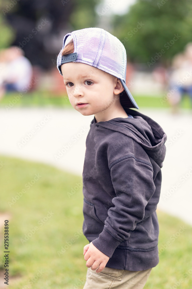Portrait of a little boy in a baseball cap backwards. Shallow depth of field. Portrait of a little boy in a baseball cap backwards. Shallow depth of field.
