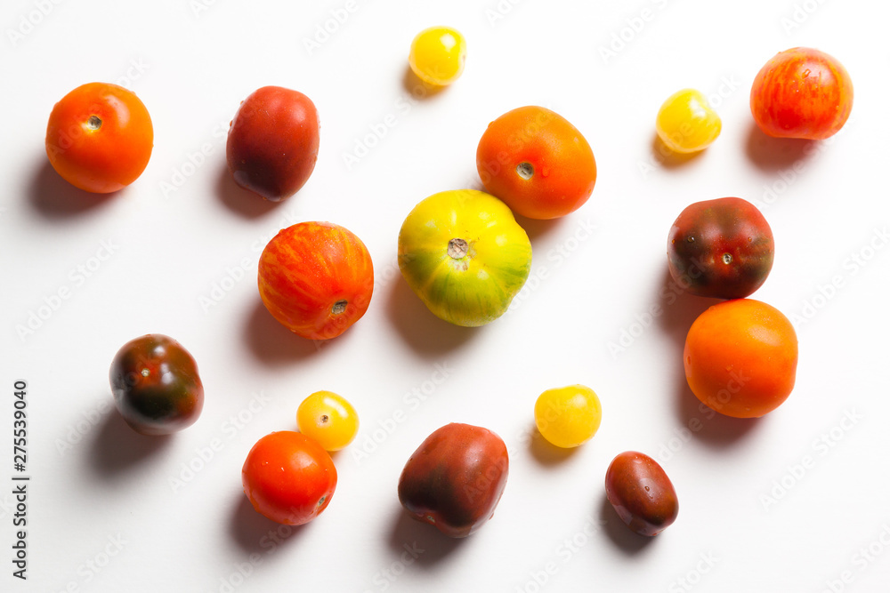 Group of heirloom tomatoes on white background.