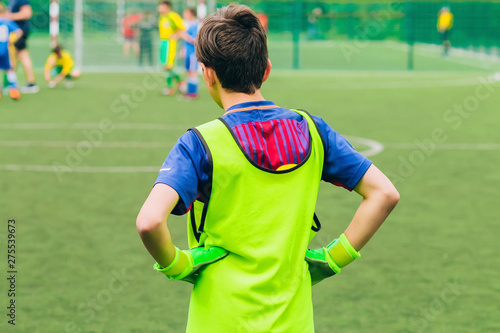 Young Soccer Goalie Goalkeeper. Young Boy Soccer Goalie. Sport activities for children. Football Match in the Backround. © Stanislav