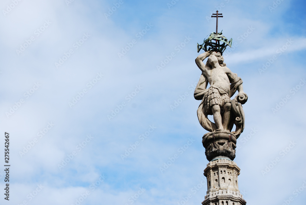 statue with blue sky and clouds