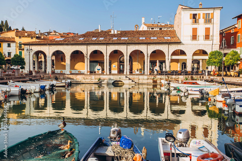 old harbour full of boats in Desenzano del Garda. Brescia, Lombardy, Italy. City Centre of Desenzano del Garda. marina on Lake Garda. photo