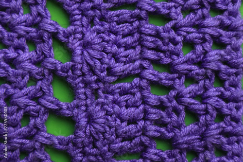 Knitted cloth on green background, close up