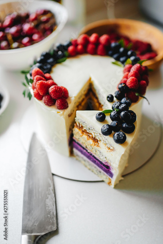 Close up. Creamy mascarpone cheese cake with strawberry and winter berries. New York Cheesecake. Close up. Christmas dessert. Healthy food. Creative atmospheric decoration.
