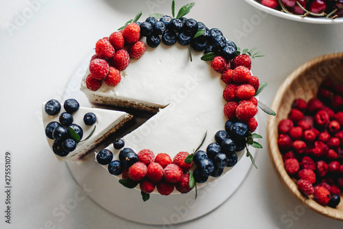 Close up. Creamy mascarpone cheese cake with strawberry and winter berries. New York Cheesecake. Close up. Christmas dessert. Healthy food. Creative atmospheric decoration.