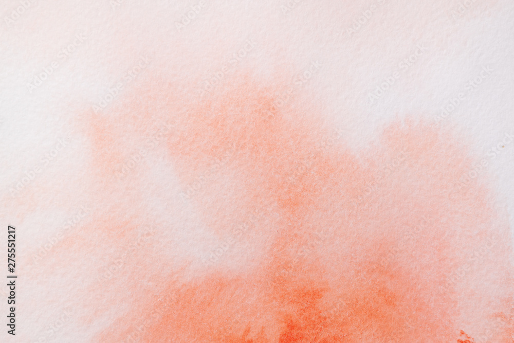 Trend photo on the theme of fashionable orange hue this season. Bright smear of watercolor paint on a white paper background.