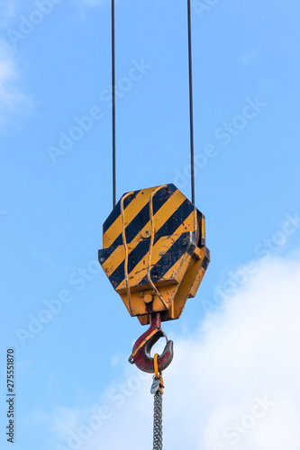 фотографія Closeup of the old lifting hook attached to sheave suspended by wire rope from b