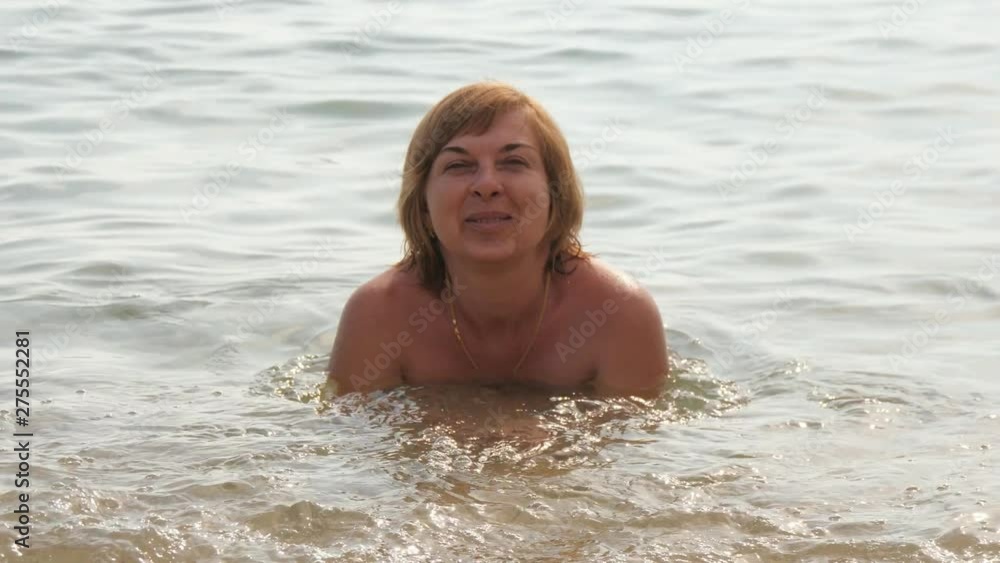 Jolly tourist lying on her stomach in Turkish resort waters in summer in slo-mo Jolly tourist lying on her stomach in Turkish resort waters in summer in slo-mo