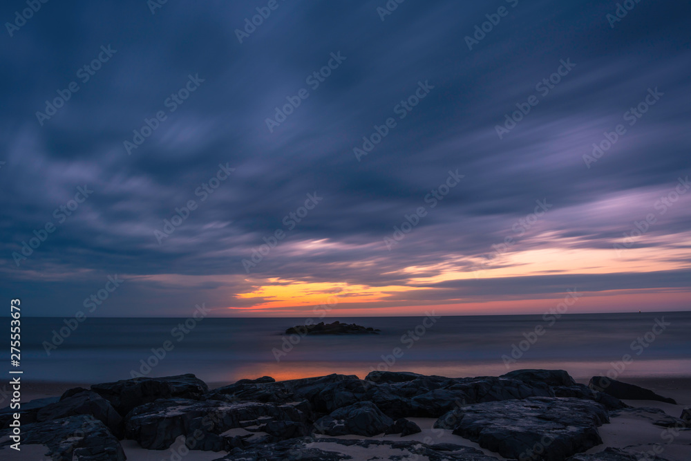 Moody morning sky over Avon by the sea beach, featuring dramatic sky on the background, shot using long exposure.