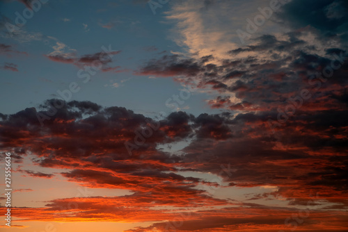 colorful beautiful sunset with gradient and reflections on the clouds. © igorgeiger