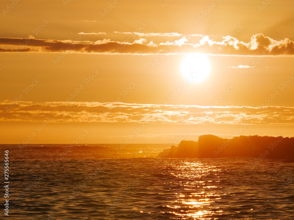 Summer sunset on ocean in Portugal with reflections on water