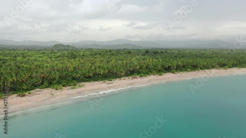 Wallpaper Mural Aerial view of palm island beach. Blue Lagoon, white sand beach and palm forest. Video from drone to island landscape with mountains. Summer evening on amazing island. Palm trees mountains background Torontodigital.ca