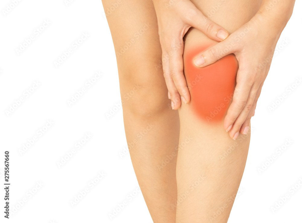  girl is massaging her painful knee on a white background.