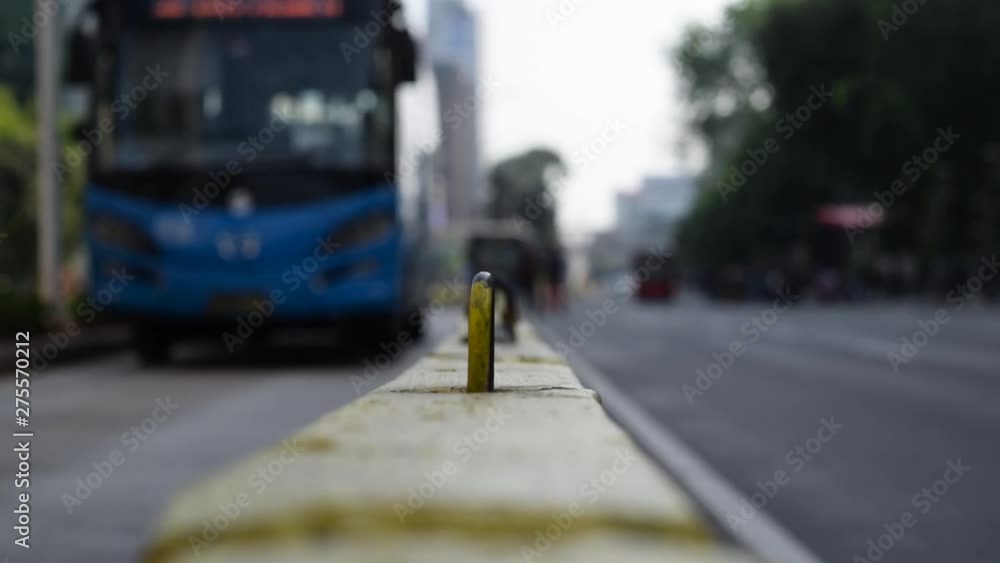 Defocused, blurry, blurred of moving traffic with a bus transport on the road. selective focus in yellow iron