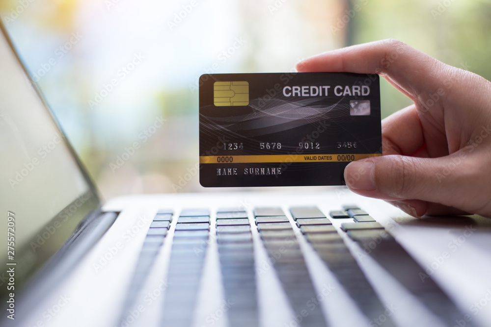 Hand holding credit card with shopping online. Online payment concept. Hand holding credit card with shopping online. Online payment concept.