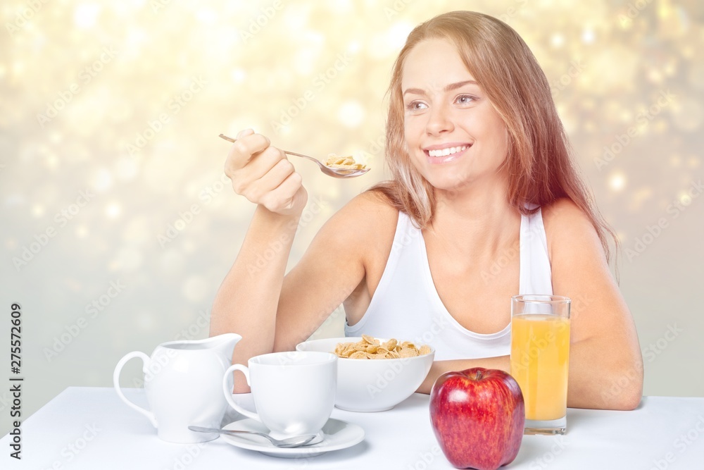 Attracive young woman enjoying tea and fruits on breakfast Attracive young woman enjoying tea and fruits on breakfast