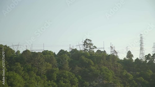 Electric cables above green forest in the top of a mountain in Portugal. photo