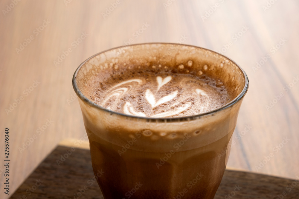 Hot latte and beautiful art latte on wooden floors Hot latte and beautiful art latte on wooden floors