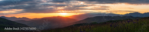Wide panorama of colorful sunset in the mountains