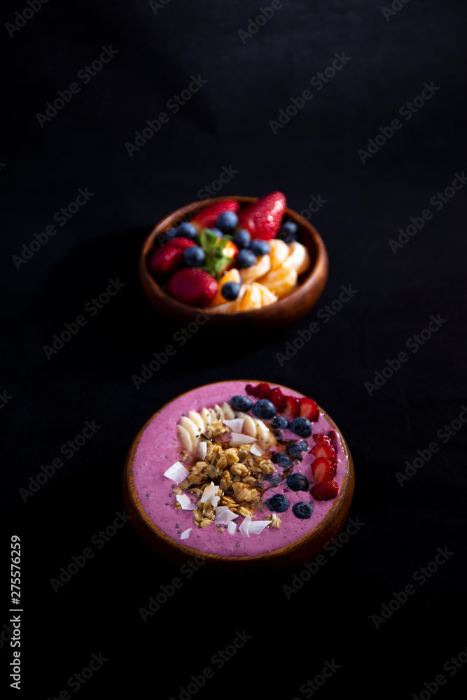Fototapeta premium Smoothie bowl with fruits in wooden bowl