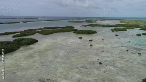 Movingturn right aerial view beach longisland green waters inof Great caribbean beach scene. Vacation on deserteds beaches. Travel destination. Tropical Travel. Los roques National Park Venezuela photo