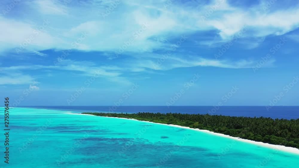 Aerial view of the turquoise and blue sea in Thailand. A blue sky above with clouds in it. An island on the left. Reefs in the water. Clouds above. Truck left Aerial view of the turquoise and blue sea in Thailand. A blue sky above with clouds in it. An island on the left. Reefs in the water. Clouds above. Truck left
