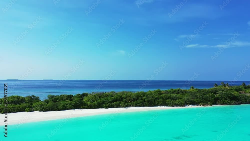Flying in a large cirlce towards an exotic island. Turquoise water the foreground, a blue sky above. Trees on this island in Barbados. Flying in a large cirlce towards an exotic island. Turquoise water the foreground, a blue sky above. Trees on this island in Barbados.