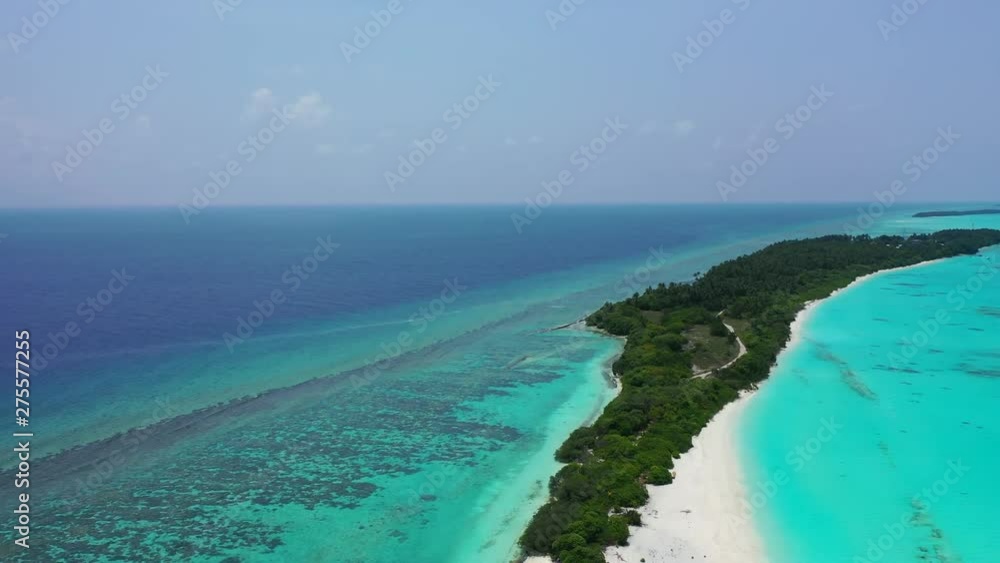 Fly above a tropical island. The sea of Hawaii is turquoise on both shores. Dolly in Fly above a tropical island. The sea of Hawaii is turquoise on both shores. Dolly in