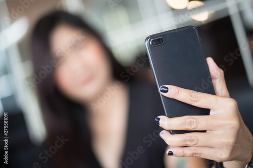 Selective focus of Woman holding smartphone for Selfie