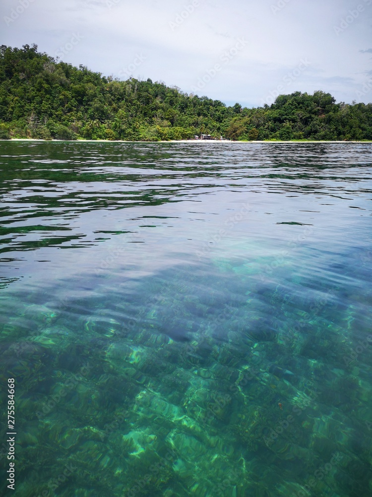 Beautiful crystal clear water with healthy coral reefs undersea from surface of Gaya Island, Tunku Abdul Rahman Park, Kota Kinabalu. Sabah, Malaysia. Borneo. Beautiful crystal clear water with healthy coral reefs undersea from surface of Gaya Island, Tunku Abdul Rahman Park, Kota Kinabalu. Sabah, Malaysia. Borneo.