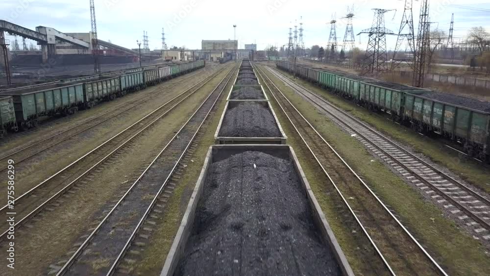 Long row of train cargo cars loaded full with fossil fuel coal. Long row of train cargo cars loaded full with fossil fuel coal.