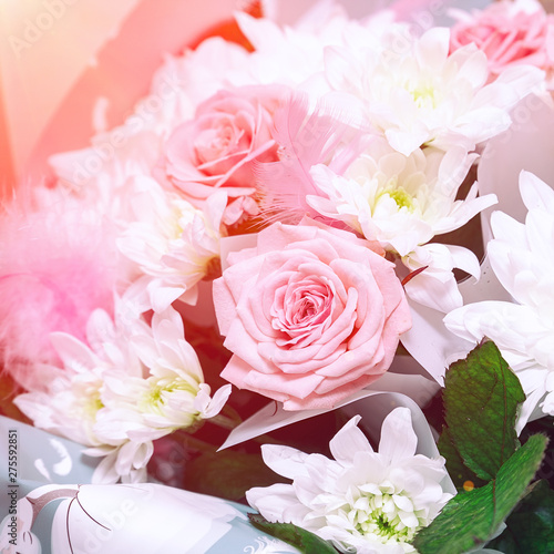 Beautiful and delicate bouquet of pink roses and white chrysanthemums
