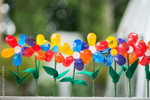 Recycled colorful plastic flowers in pot.Recycle decoration.