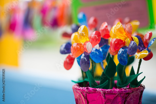 Recycled colorful plastic flowers in pot.Recycle decoration.