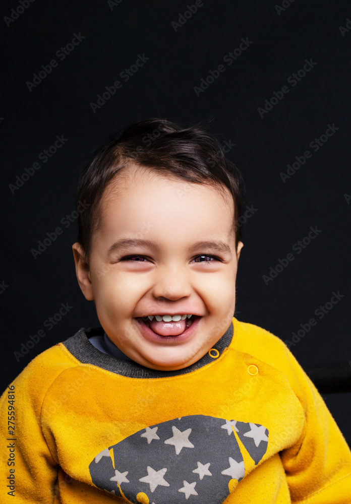 Portrait of a contented dirty handsome boy on a dark background. The boy ate something tasty Portrait of a contented dirty handsome boy on a dark background. The boy ate something tasty