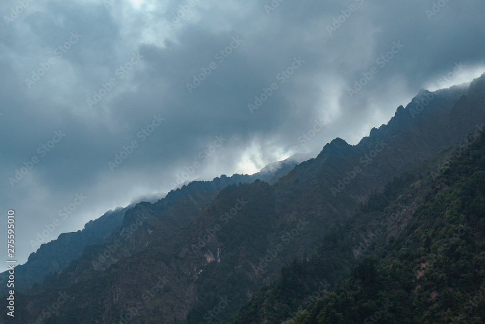 View of mountains covered by clouds