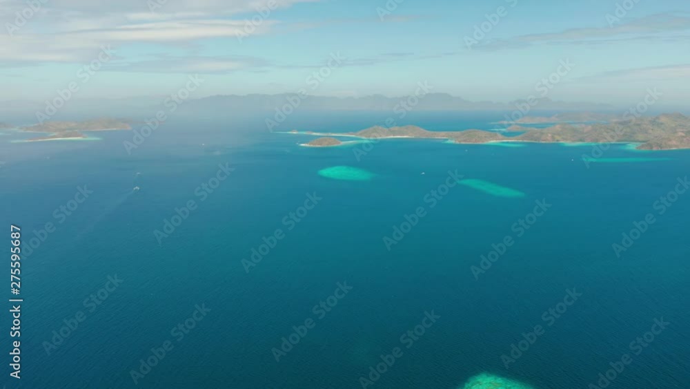 aerial view tropical islands with blue lagoon, coral reef and sandy beach. Palawan, Philippines. Islands of the Malayan archipelago with turquoise lagoons. aerial view tropical islands with blue lagoon, coral reef and sandy beach. Palawan, Philippines. Islands of the Malayan archipelago with turquoise lagoons.