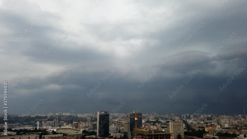 Storm over the city. Storm clouds with lightning over the city. Thunderstorm covers the city.