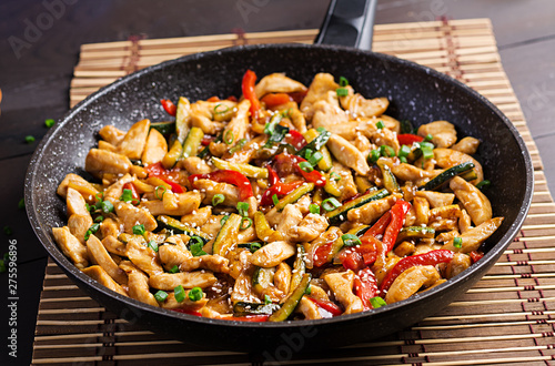 Stir fry chicken, zucchini, sweet peppers and green onion. Asian cuisine