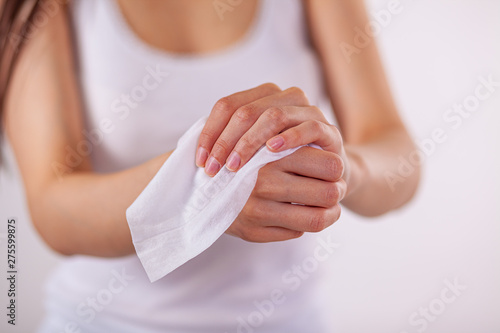 Close-up scene: girl cleaning hands with wet wipes
