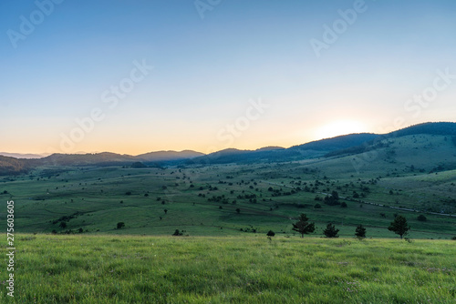 Amazing mountain landscape with colorful vivid sunset on clear sky, natural outdoor travel background