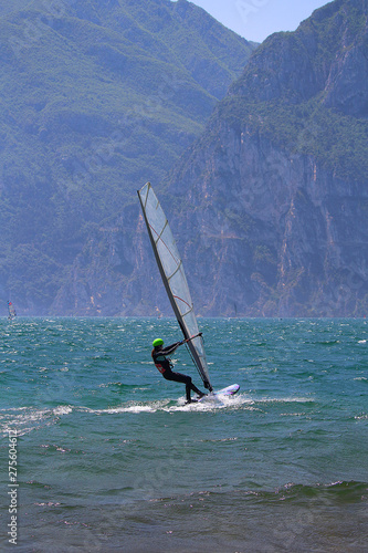 Young woman windsurfing at Lake Garda glistening in the sun (Torbole, Italy) © Ines Porada