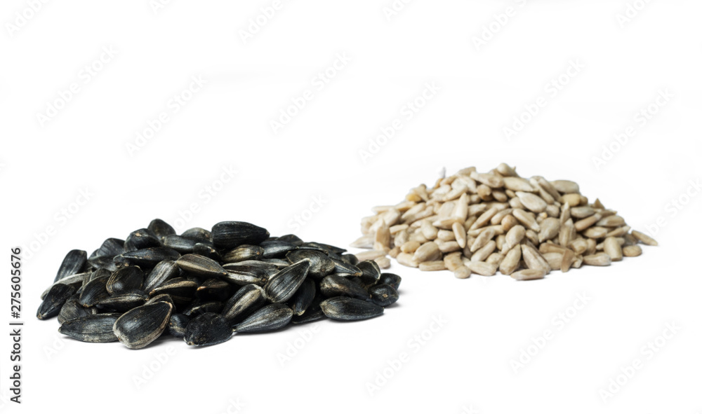 Two handfuls sunflower seeds and kernels isolated on the white background. Selective focus. Two handfuls sunflower seeds and kernels isolated on the white background. Selective focus.
