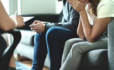 Hopeless and upset couple in therapy. Counseling or meeting with marriage counselor or adoption psychologist. Argument and dispute about divorce, alimony, prenup, cheating, betrayal or custody battle.