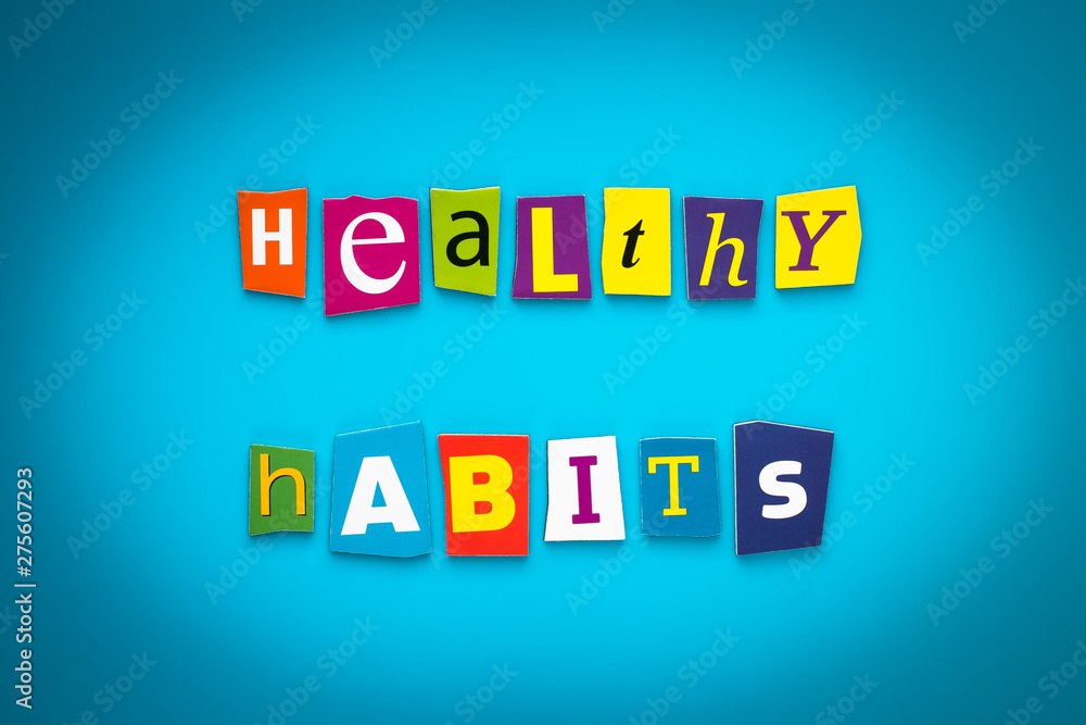 Obraz premium A word writing text - healthy habits - from cut letters on a blue background. Headline, card, banner with inscription. Psychologic, health concept. Caption, heading from colored letters. Message 